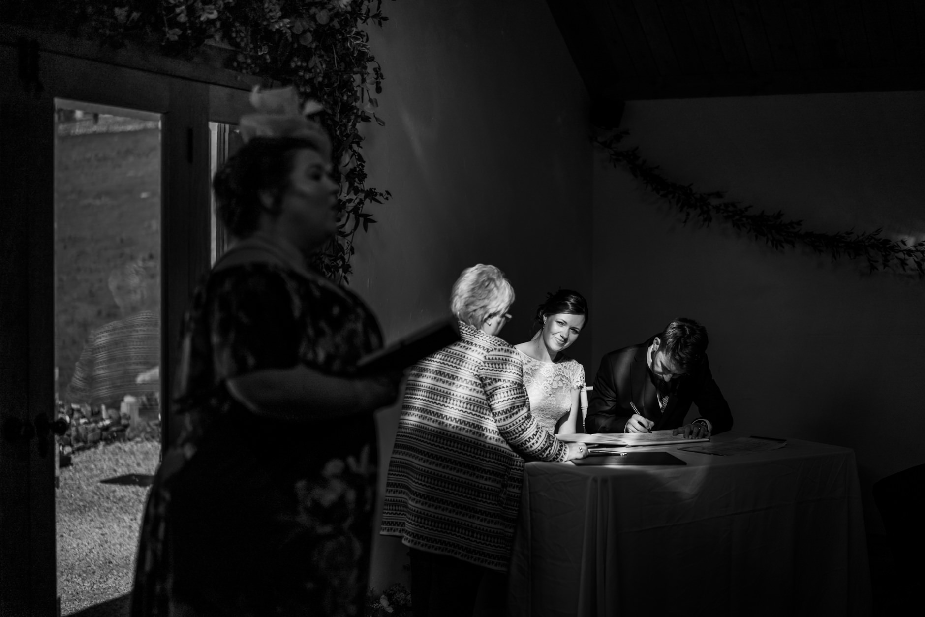 bride and groom sign their wedding register at knipe hall in the dairy
