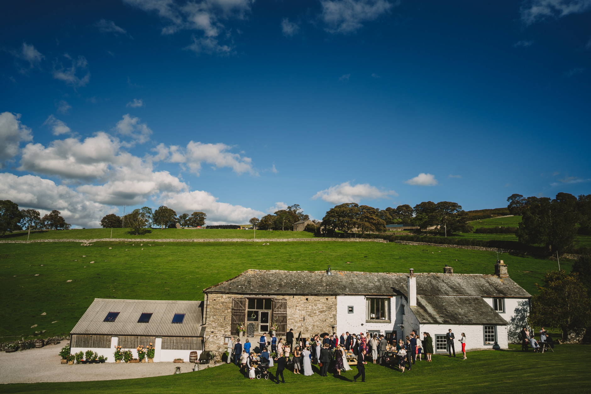 guests enjoying outdoor drinks reception at knipe hall wedding in september