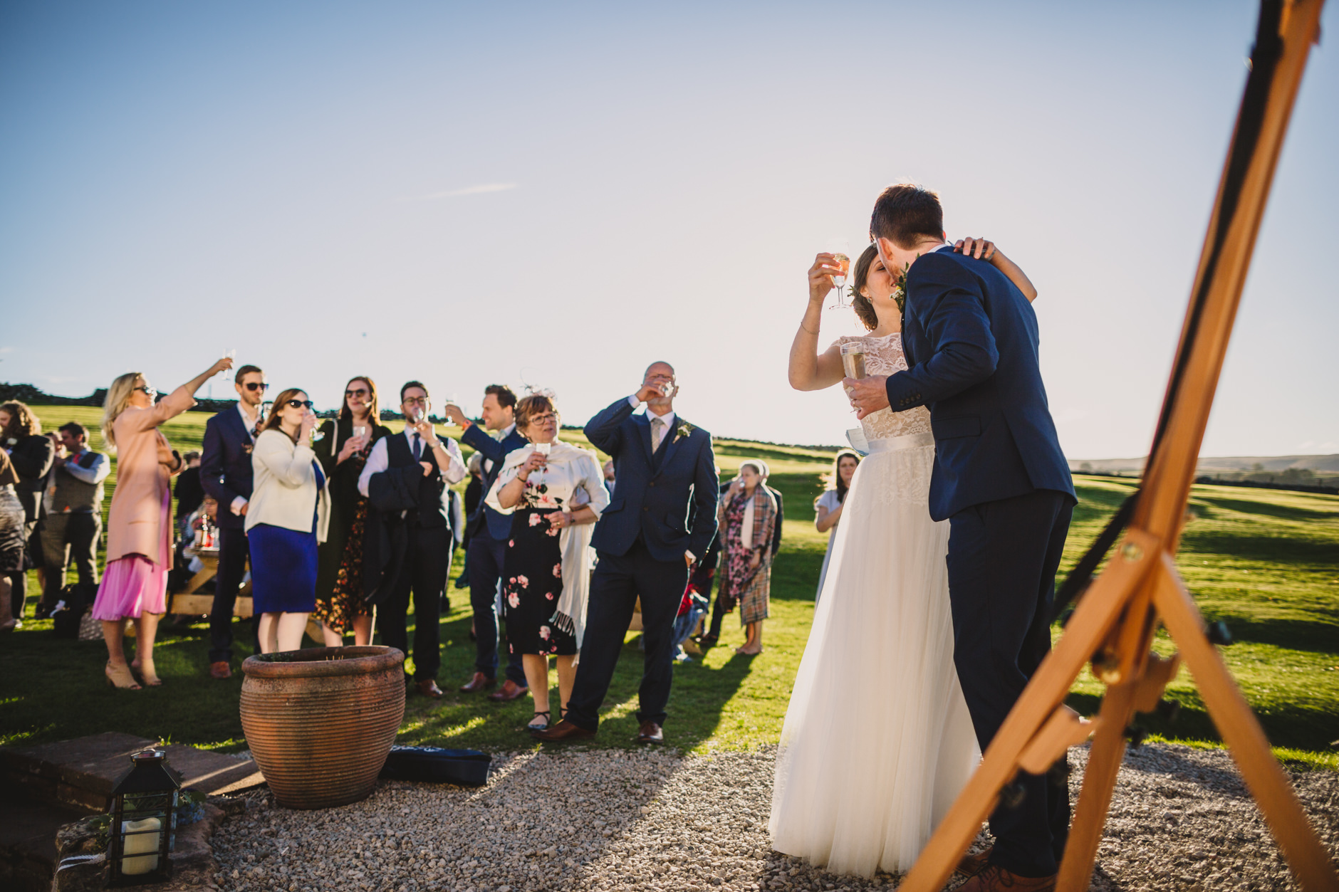 bride and groom kiss during outdoor speeches at knipe hall