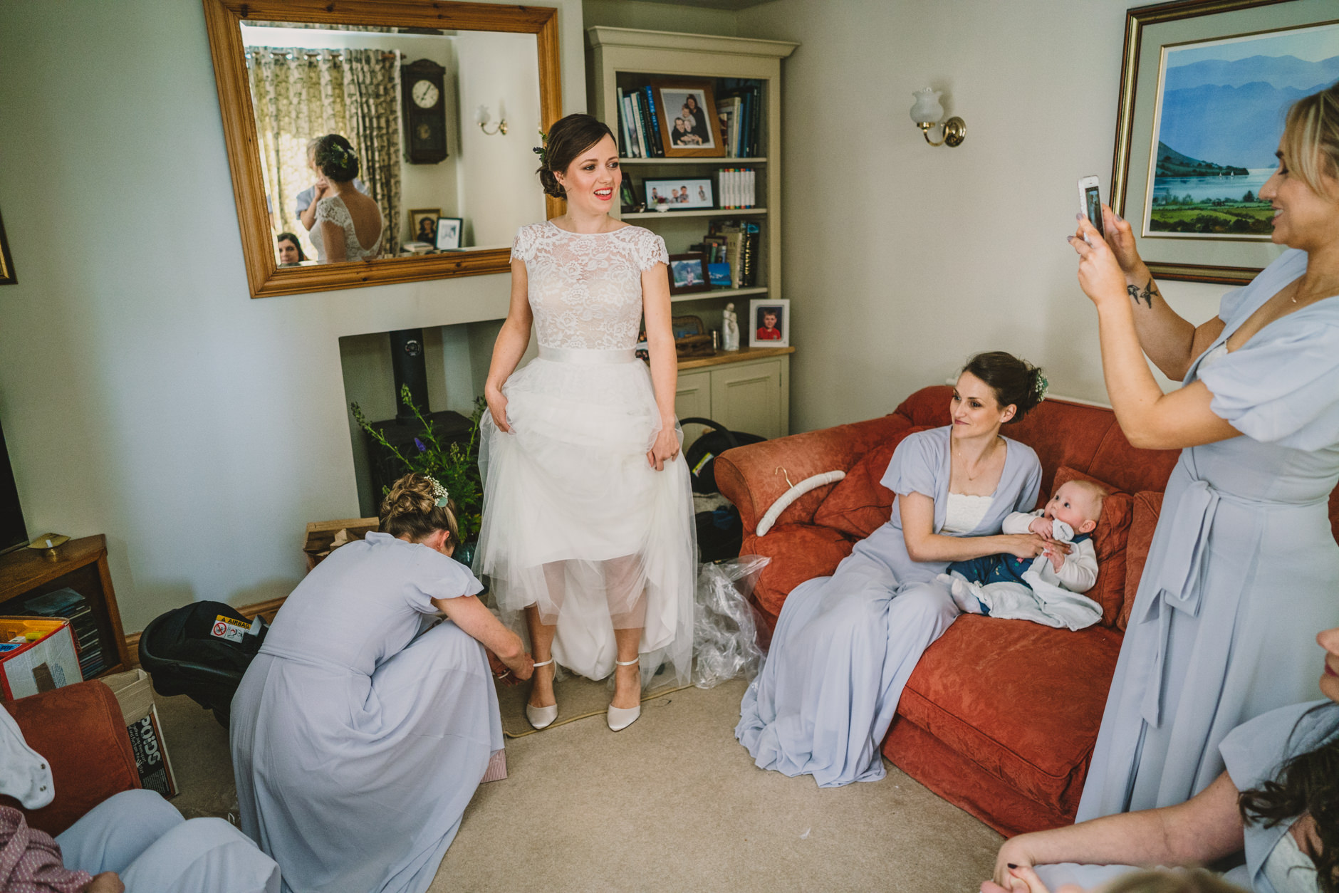 bride getting ready in her anna kara wedding dress at parents house