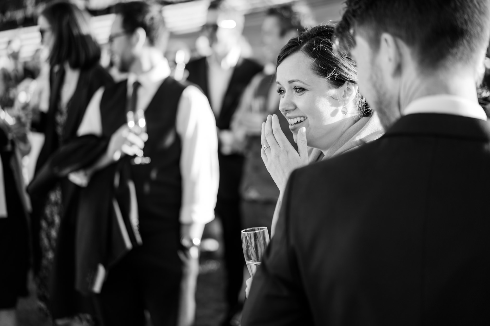 bride laughing during speeches outdoors at knipe hall
