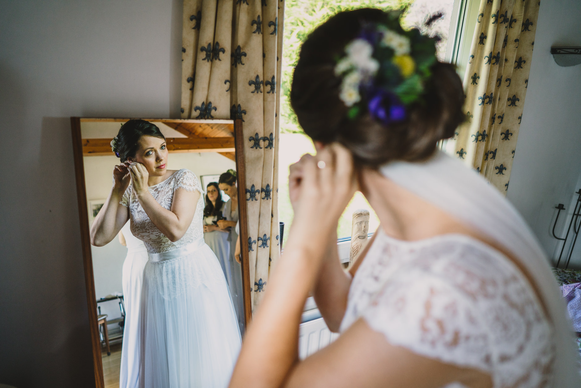 bride putting in her earring ahead of knipe hall wedding