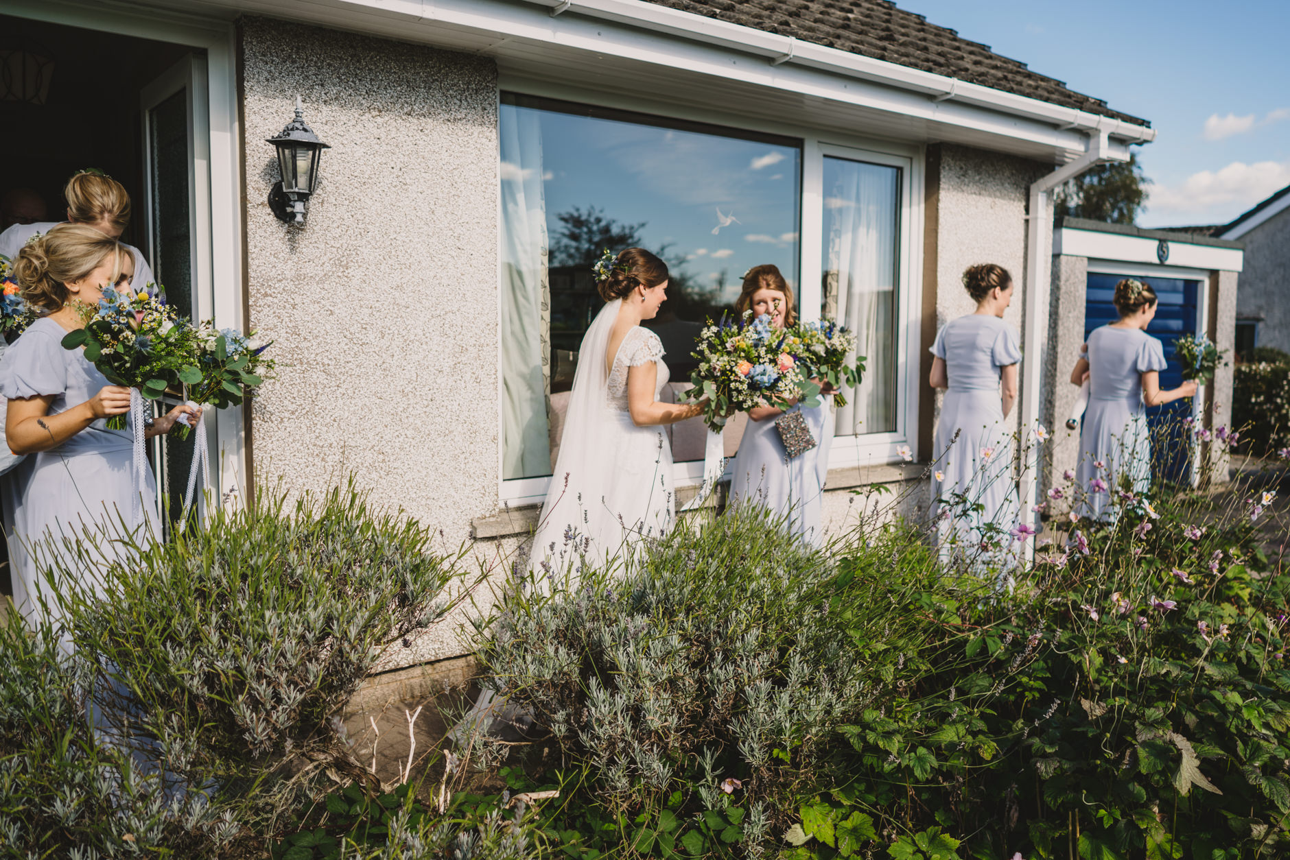 bride and her bridesmaids leaving home for diy knipe hall wedding in cumbria
