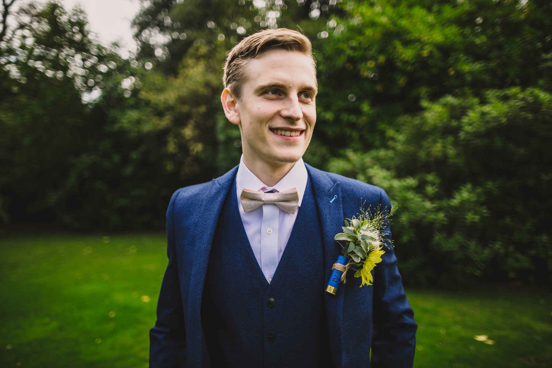 portrait of groom dressed in blue with bowtie at east bridgford hill