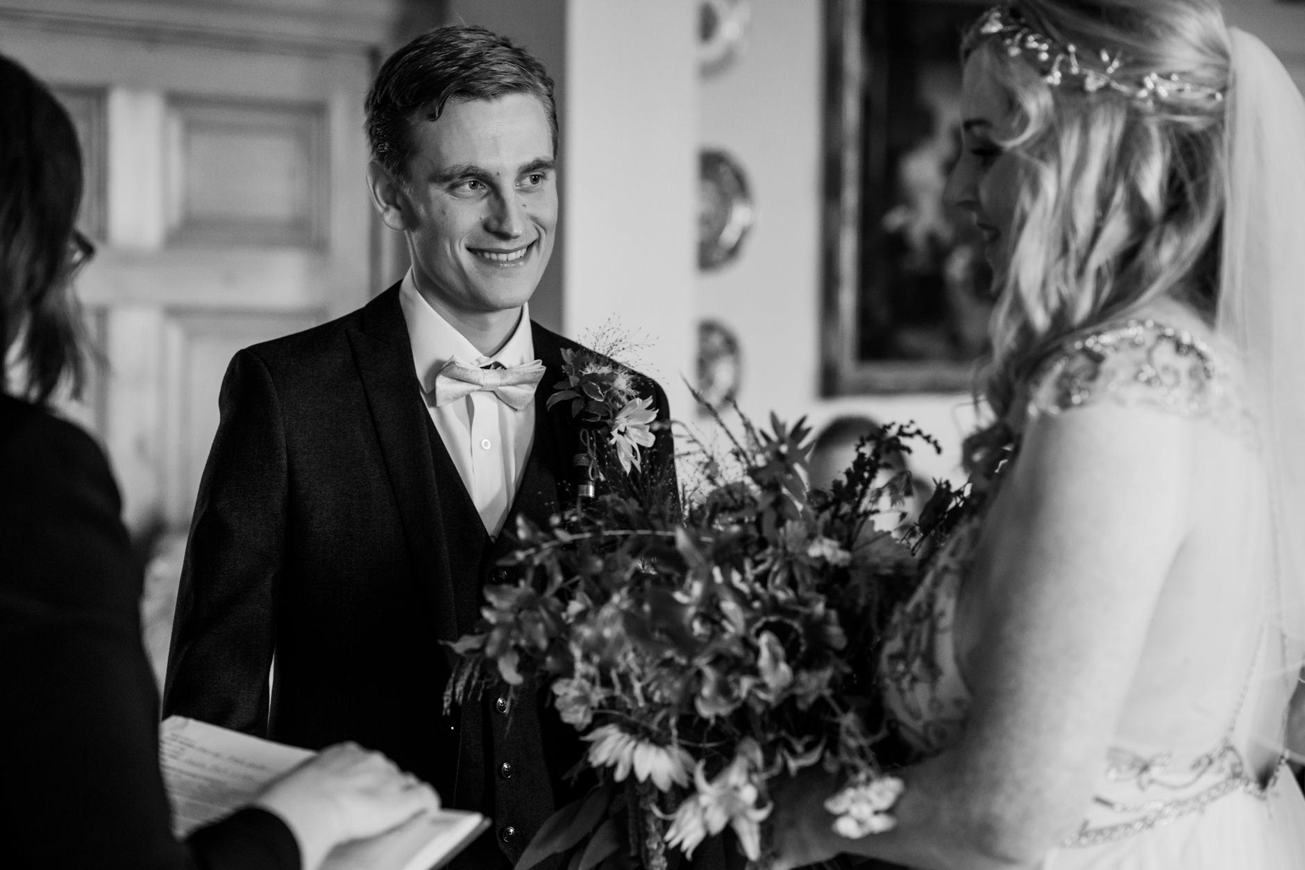 groom smiles at his bride during east bridgford hill wedding ceremony