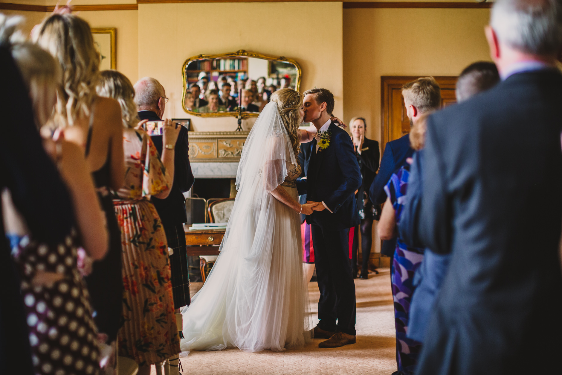 bride and groom kiss during their bohemian east bridgford hill wedding ceremony
