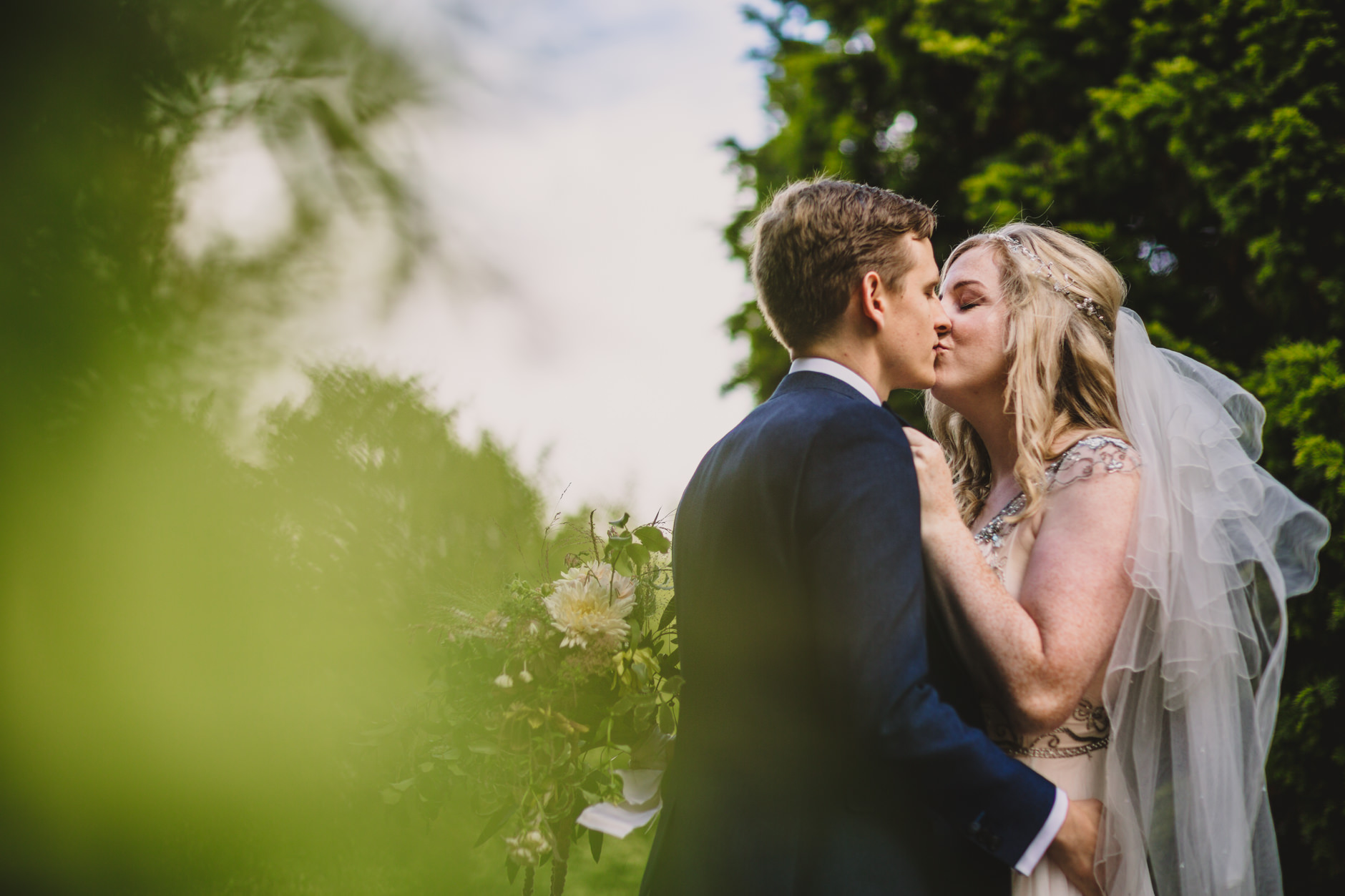 portrait of newly wed couple kissing at east bridgford hill