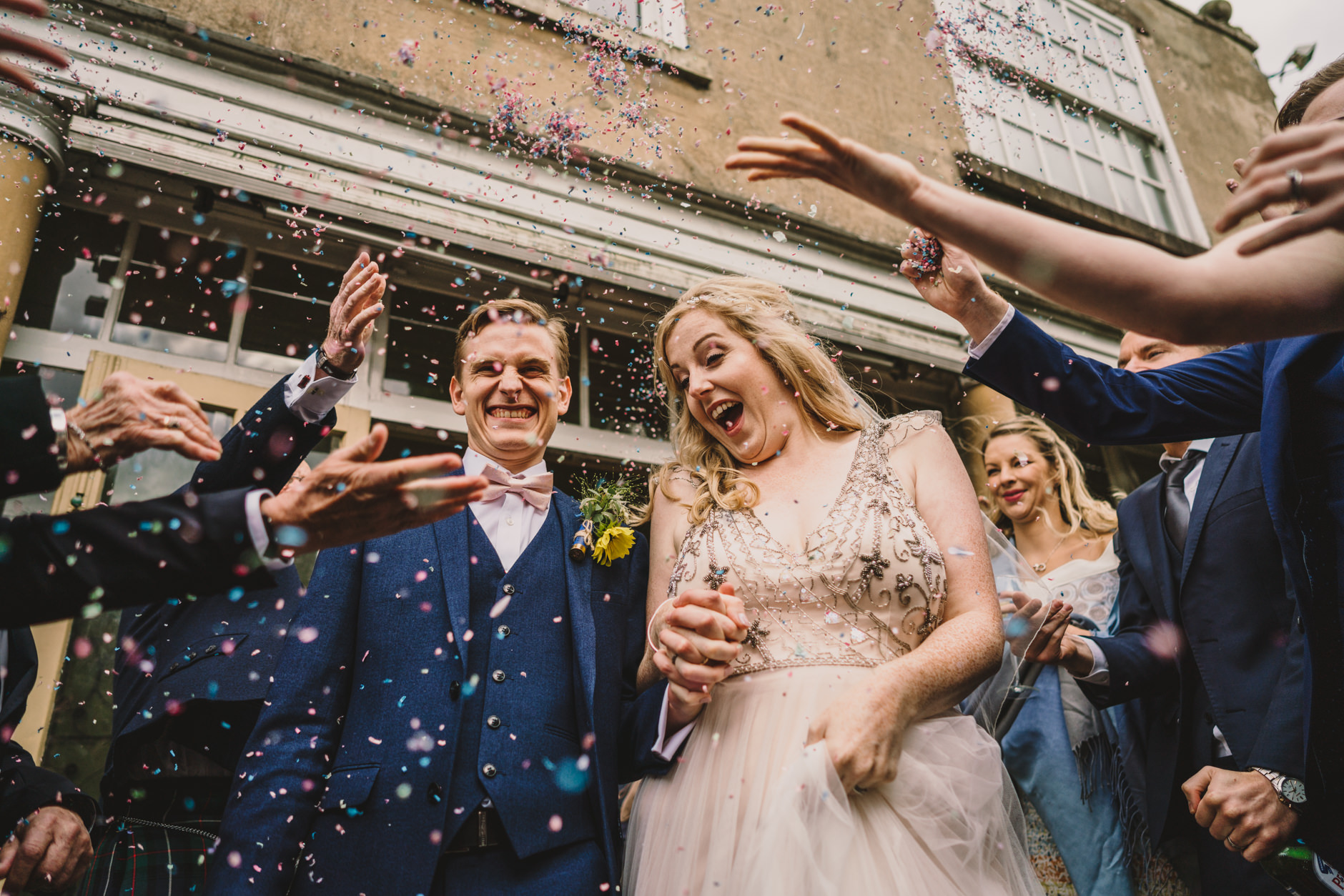 wedding couple being showered with confetti outside east bridgford hill