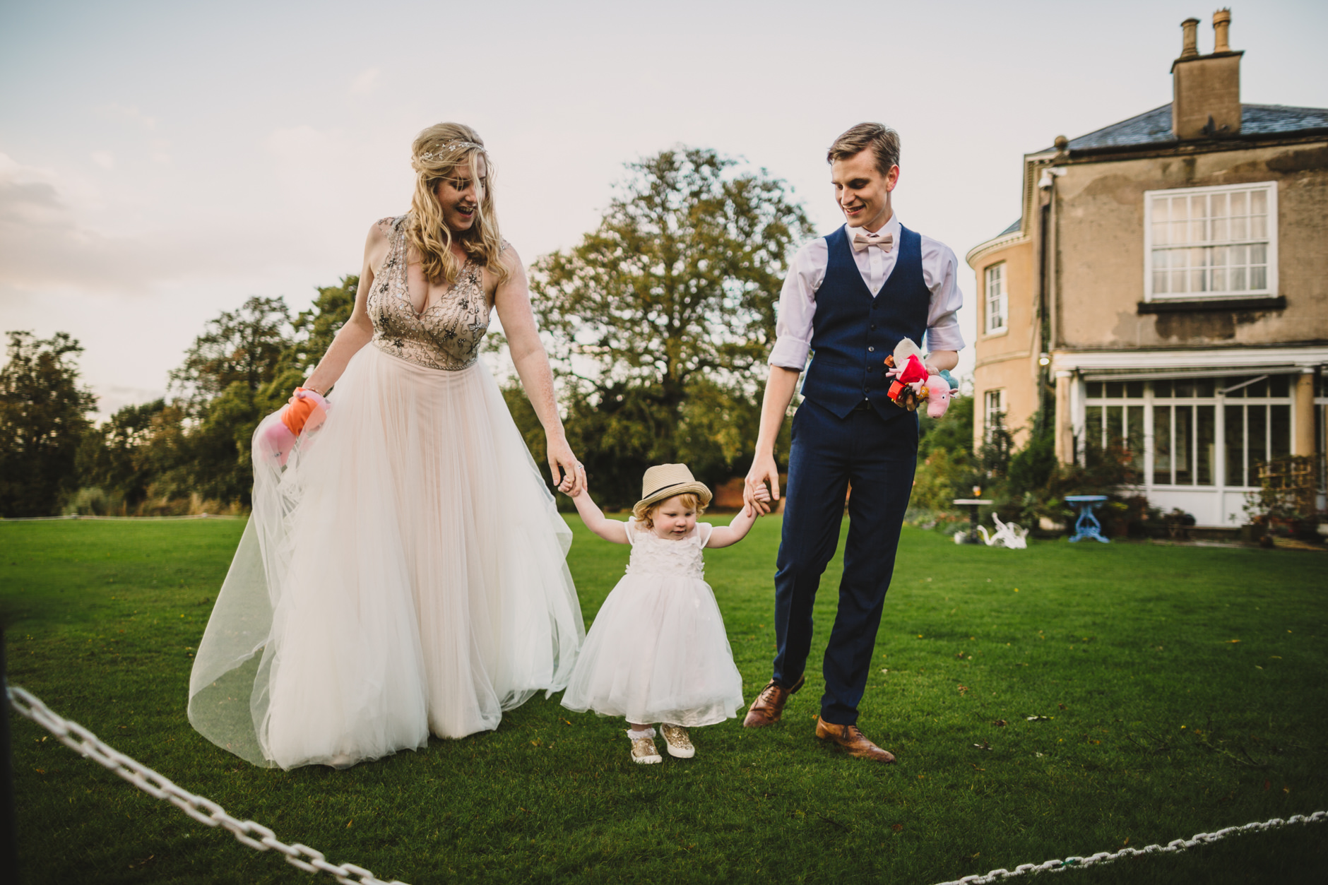 bride and groom with their yound daughter at east bridgford hill