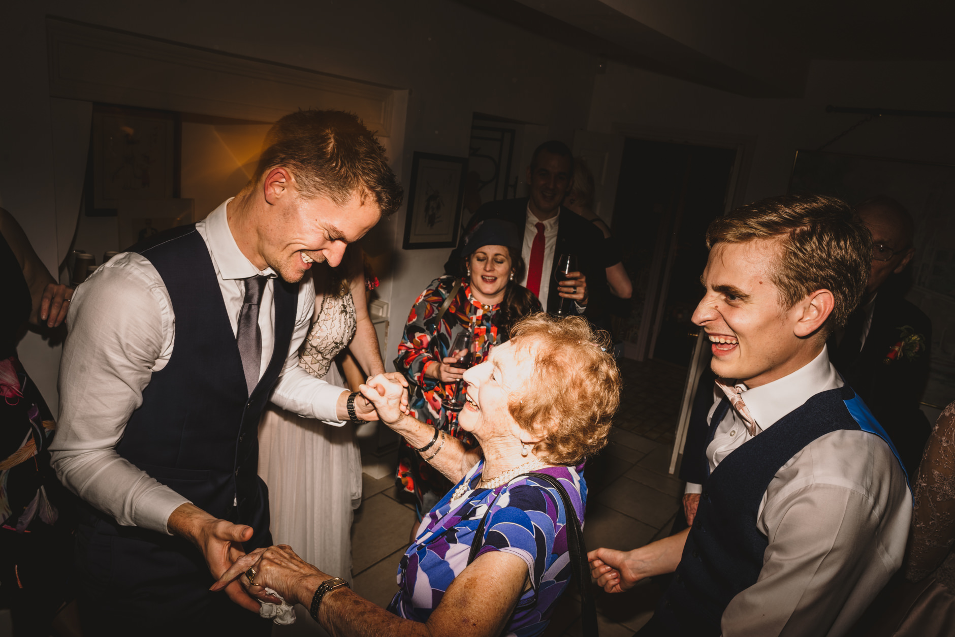 groom's grandma dances with a young guest at east bridgford hill wedding