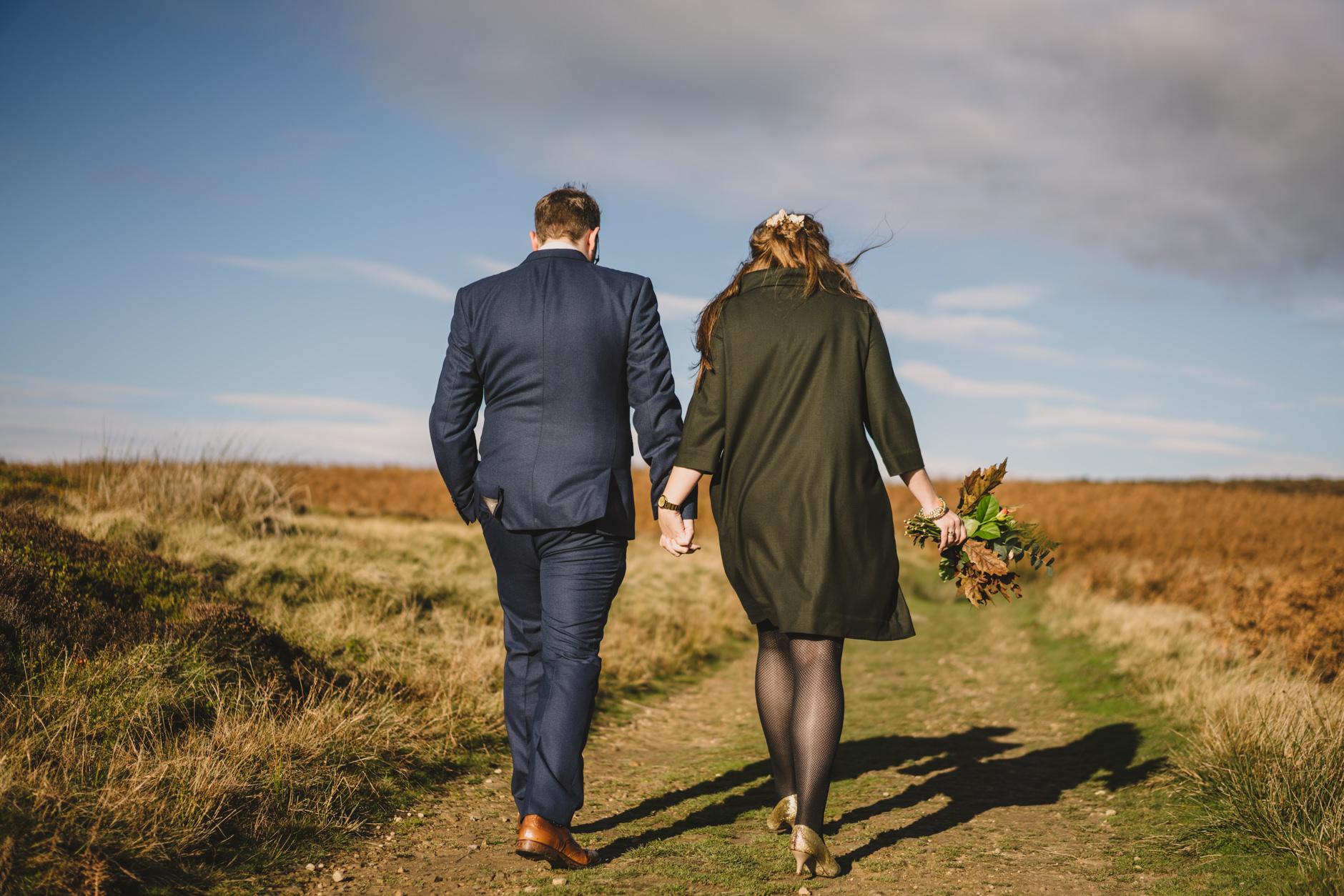 wedding couple walk on ilkley moor in autumn sunshine