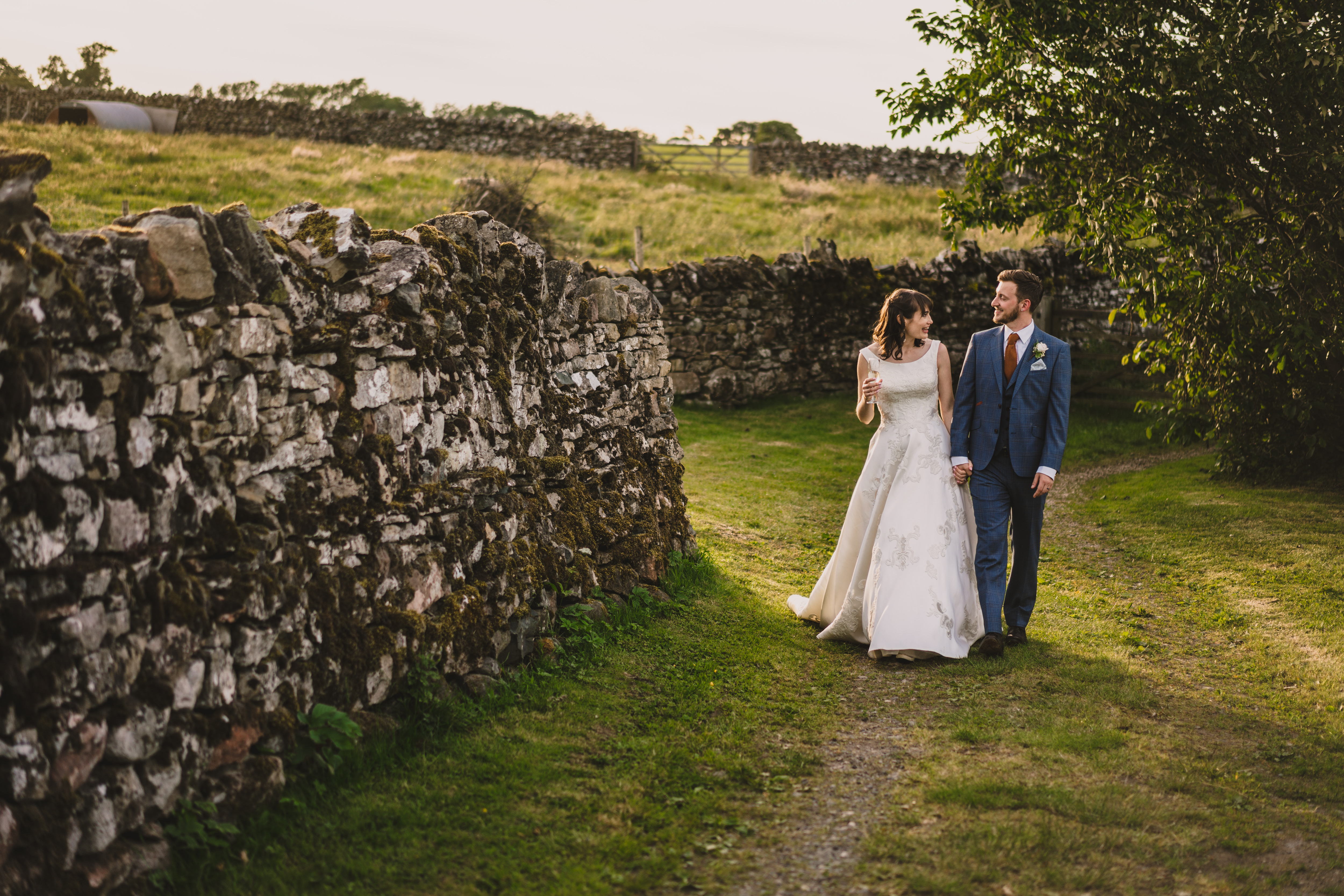 wedding couple strolling in the grounds at askham hall
