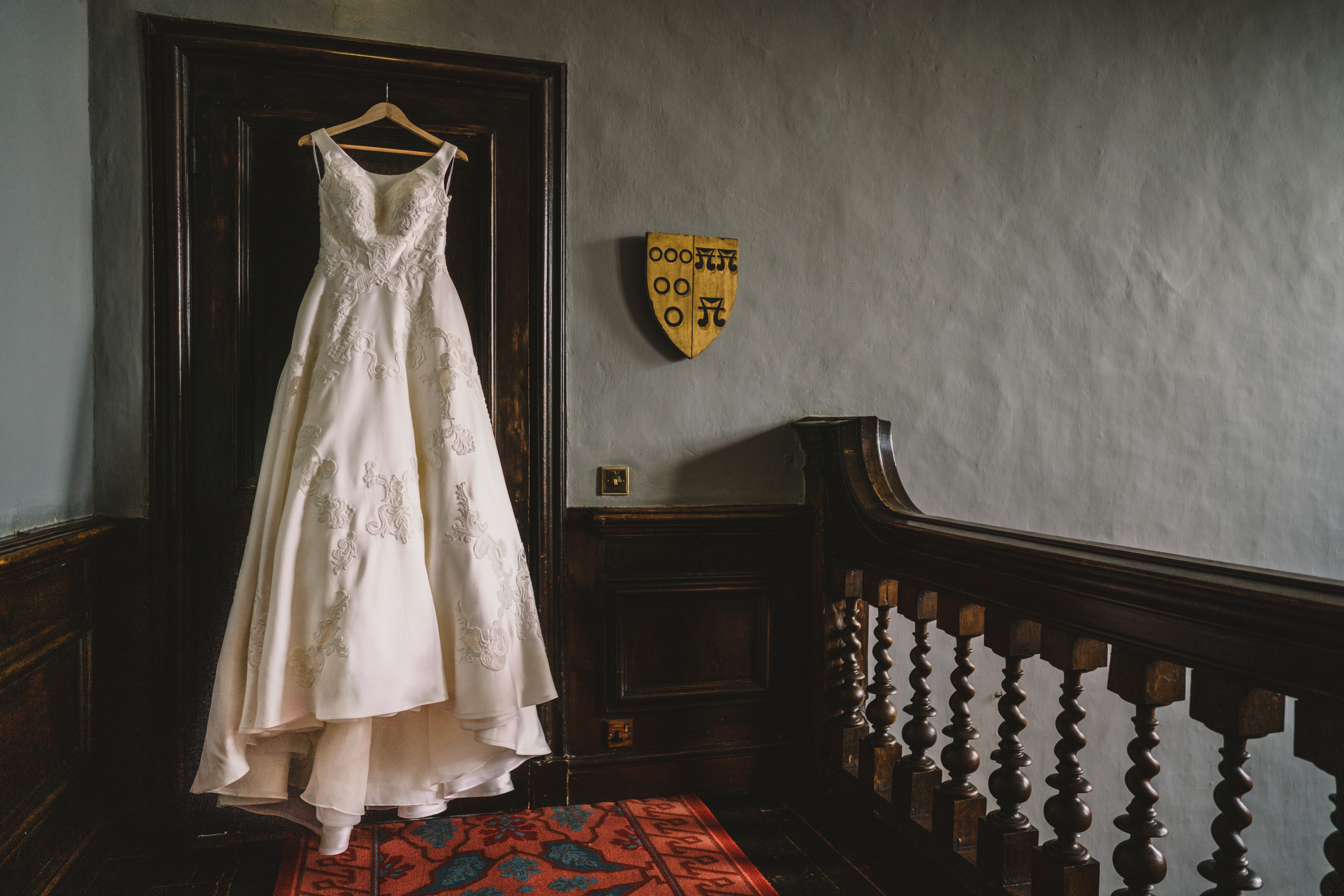 ellis bridal wedding dress hanging in the hallway at askham hall
