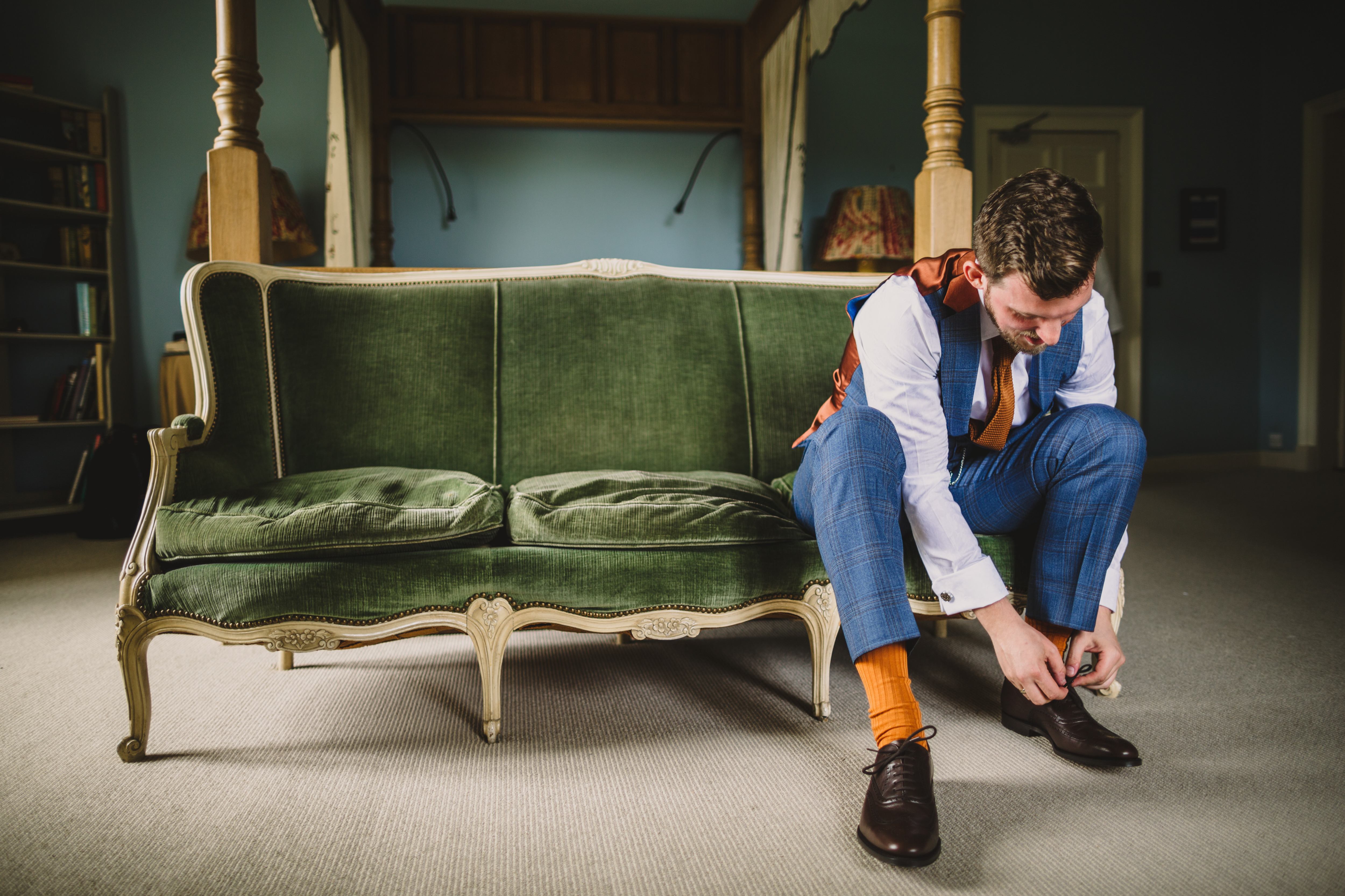 groom putting shoes on at askham hall wedding
