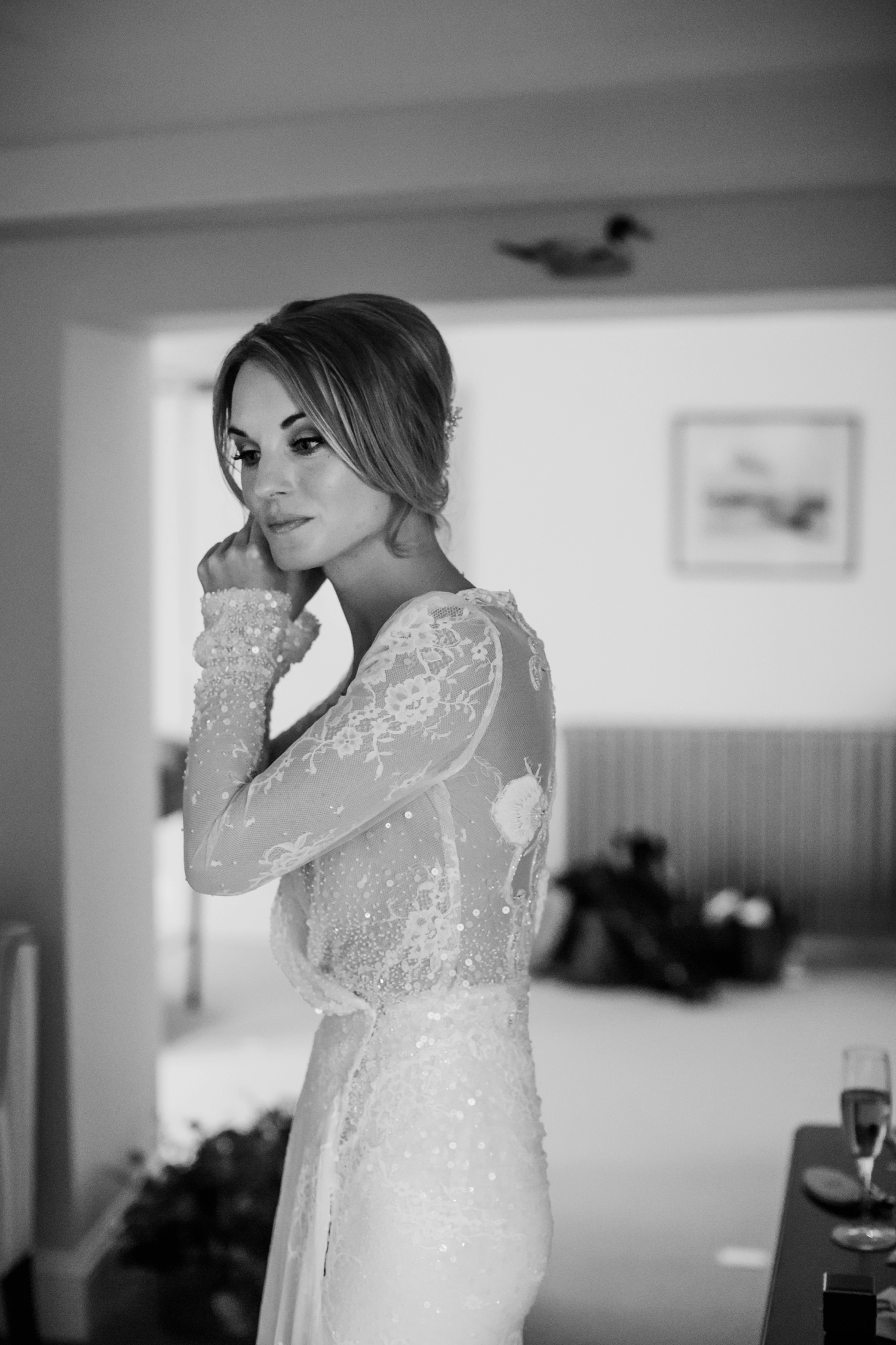 Black and white shot of bride getting ready at Holkham Hall